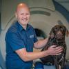 Orthopaedic and spinal surgery specialist Charlie Sale with Labradoodle Billy at Oakwood Veterinary Referrals