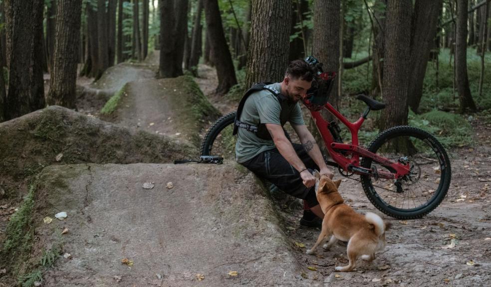 A cyclist with his dog