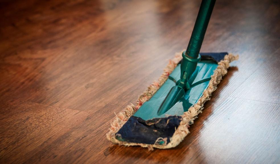 Brown wooden floor being cleaned