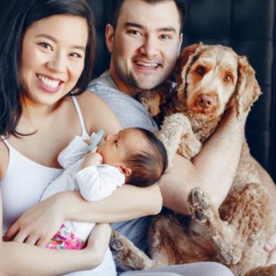 Family with a new baby and a dog