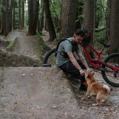 A cyclist with his dog