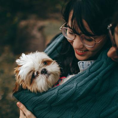 Selective Focus Photography of White and Tan Shih Tzu Puppy Carrying by Smiling Woman