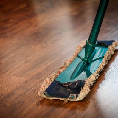 Brown wooden floor being cleaned